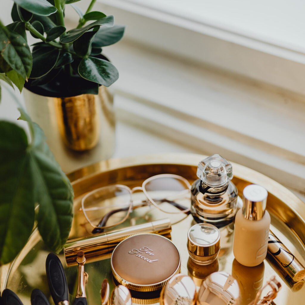 kaboompics makeup essentials on a golden tray 11322