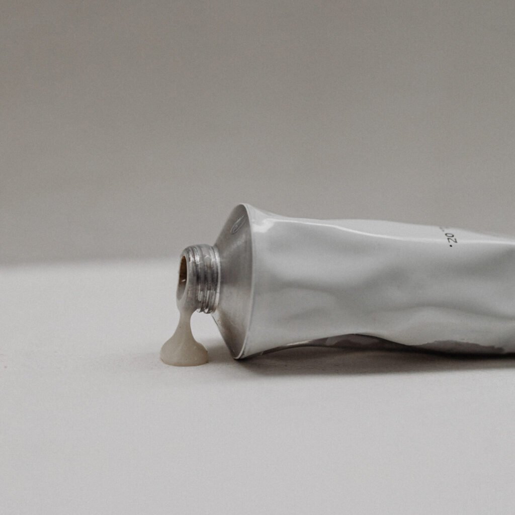 kaboompics ugc style image of a hand and body scrub tube on a neutral background free stock photo 34708